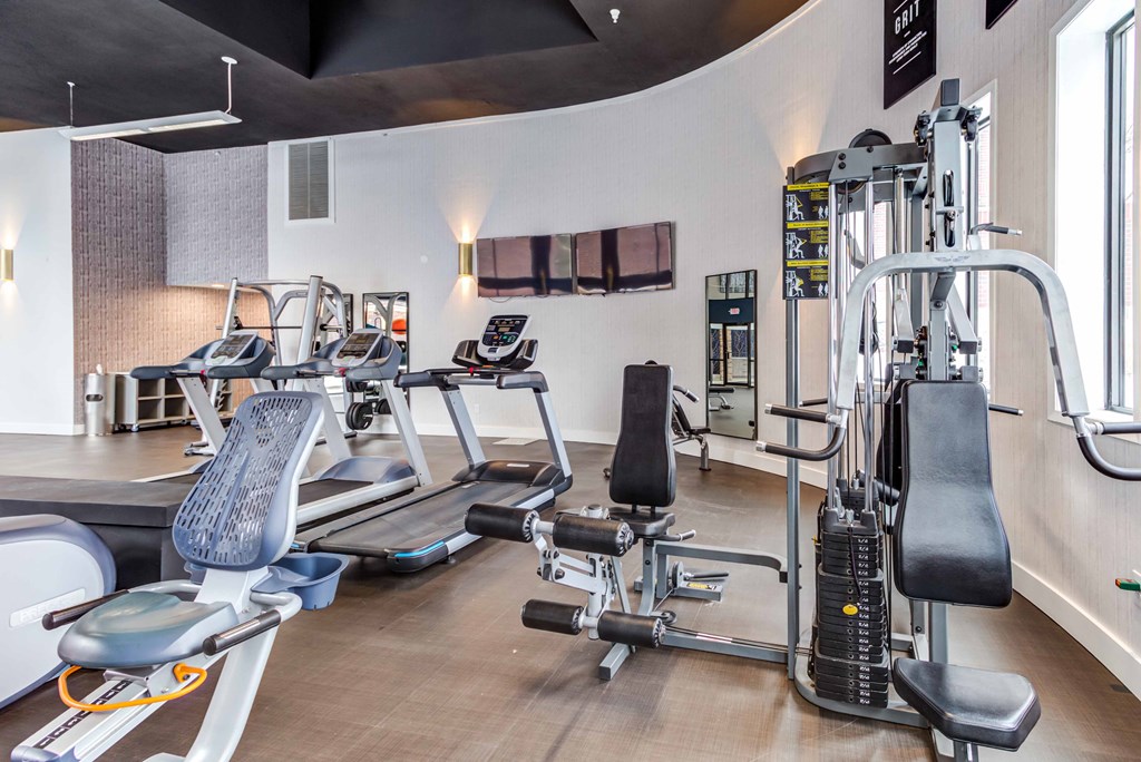 a gym with treadmills and other exercise equipment