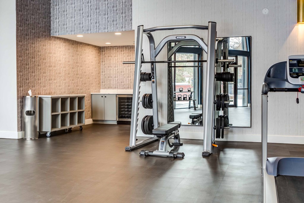 a gym with weights and cardio equipment in the lobby of a building