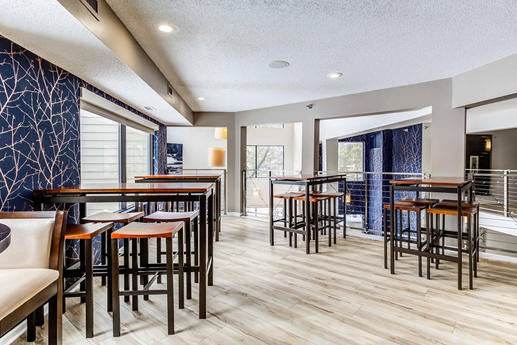a dining area with tables and chairs and a balcony