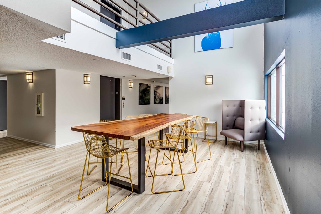 a dining room with a wooden table and chairs