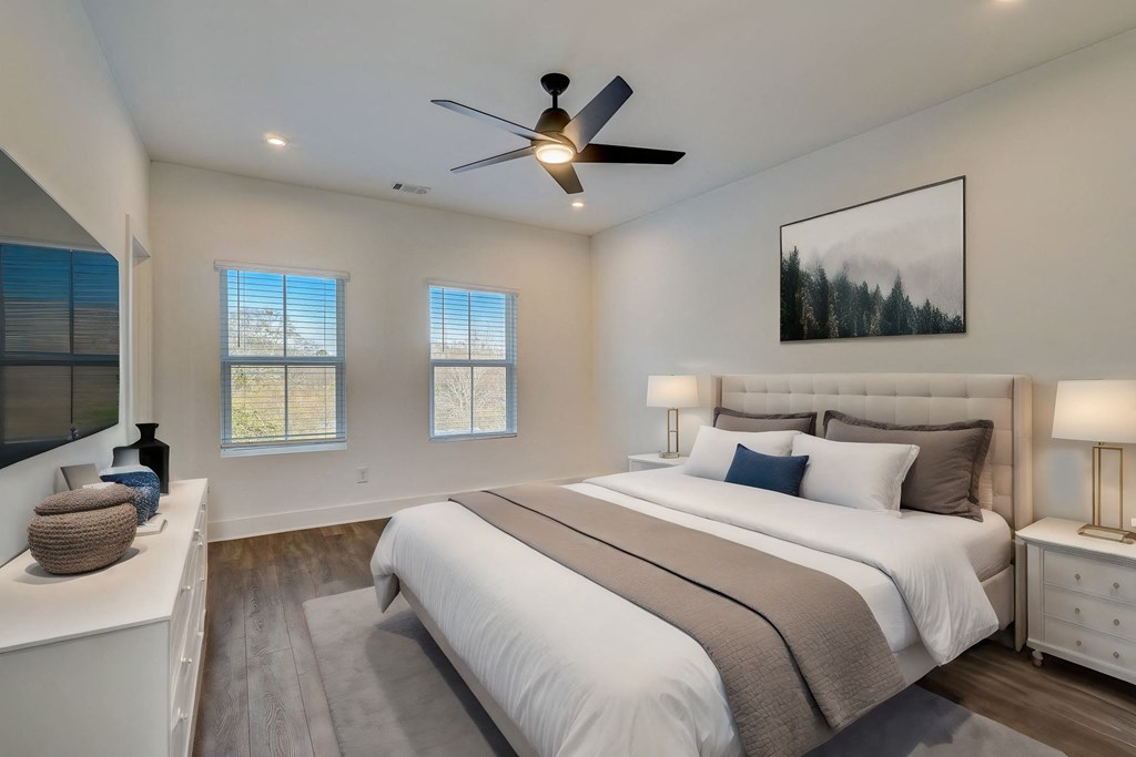 Large bedroom with windows that bring in plenty of natural light in pet-friendly townhomes at Henley Avondale in Avondale Estates, GA.
