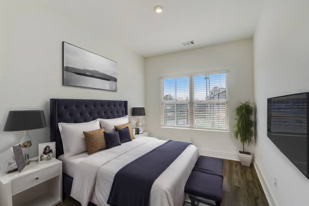 Spacious bedroom with large window in pet-friendly townhomes at Henley Avondale in Avondale Estates, GA.