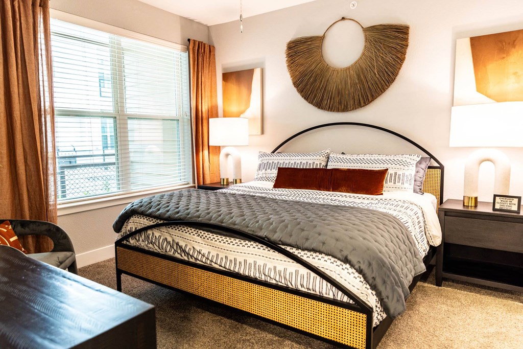 a bedroom with a bed and a large window