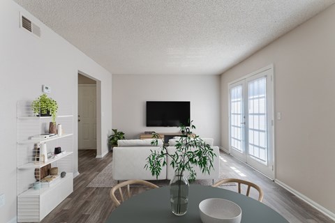 A living room with a grey table and a white couch.