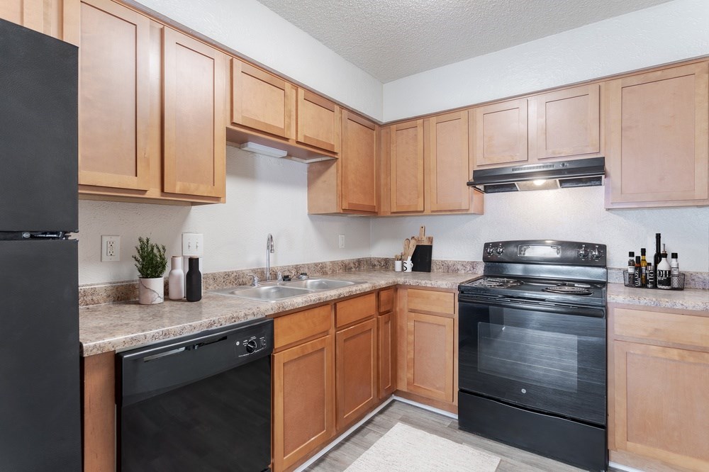 Modern kitchen with black appliances at Hickory Lake apartments in Antioch, TN 37013, near Southeast Nashville.