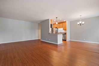 Two Bedroom Apartments in Santa Clara, CA - Hidden Lake - Open-Concept Living Area with Wood-Style Flooring, Grey Walls, and Dining Area.