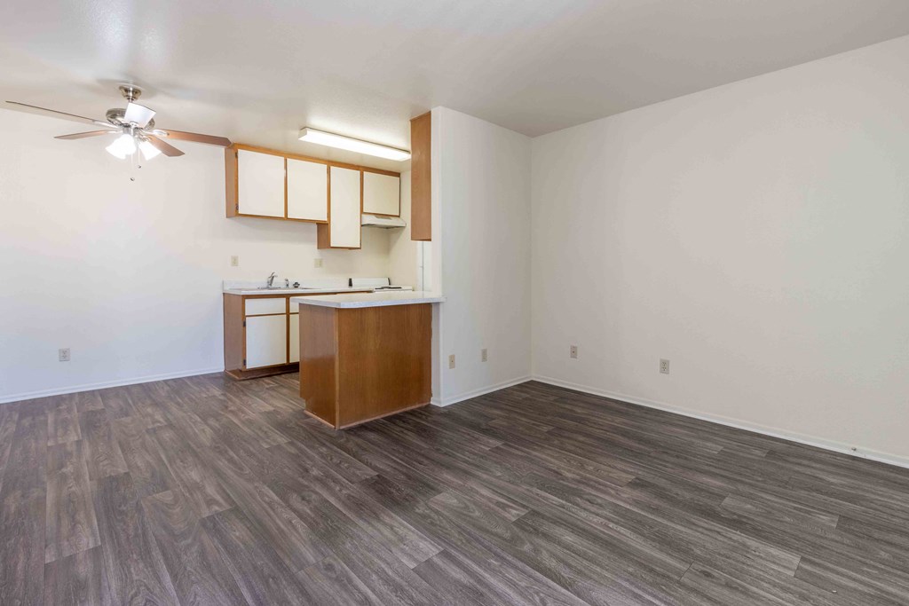 High Desert Villas apartments in Victorville California an empty living room with a kitchen and a ceiling fan