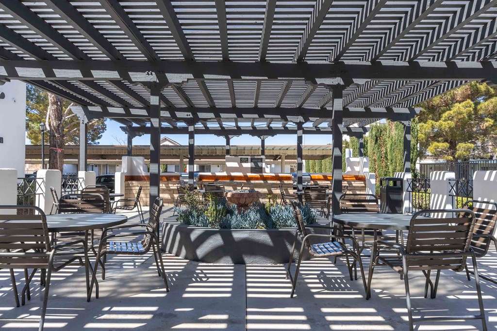 High Desert Villas apartments in Victorville California a patio with tables and chairs and a pergola