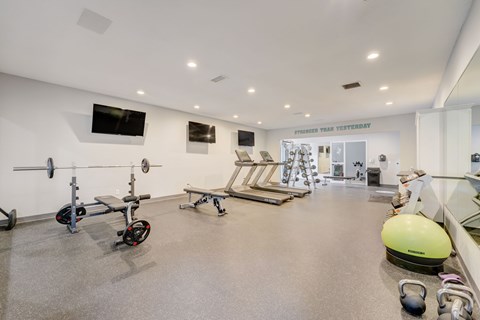 Modern fitness center with cardio and strength equipment at Hinton Heights Apartments in Cottage Grove, MN, serving residents of 1, 2, and 3 bedroom apartments for rent.