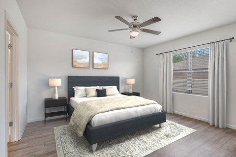 A bedroom with a bed, two lamps, and pictures on the wall.