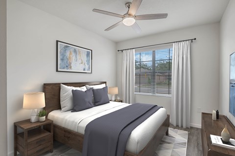 A bedroom with a bed, nightstand, and a ceiling fan.