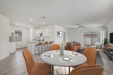 A modern dining room with a round table and chairs.
