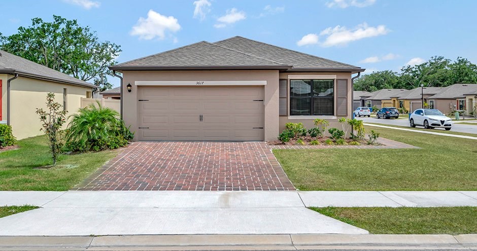 A house with a garage door that says "BUILT" on it.
