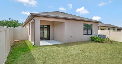 A house with a grey roof and a white fence.