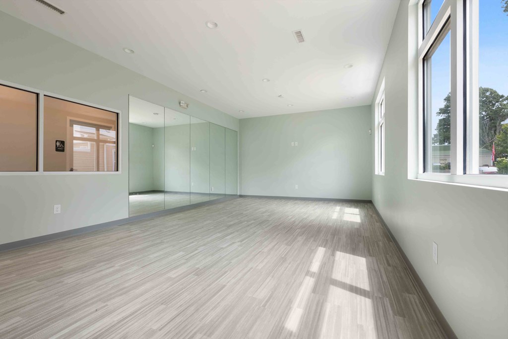 Spacious multipurpose room with wall mirrors at Hunters Pointe apartments in Charlotte, NC 28213, near UNC Charlotte.