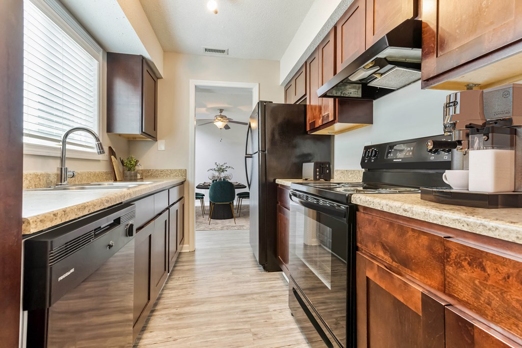 Modern kitchen with black appliances at Hunters Pointe apartments in Charlotte, NC 28213, near UNC Charlotte