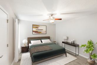 Hunters Pointe Apartments in Charlotte North Carolina photo of a bedroom with a bed and a ceiling fan - Photo Gallery