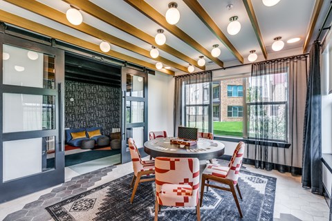 A dining room with a round table and chairs.