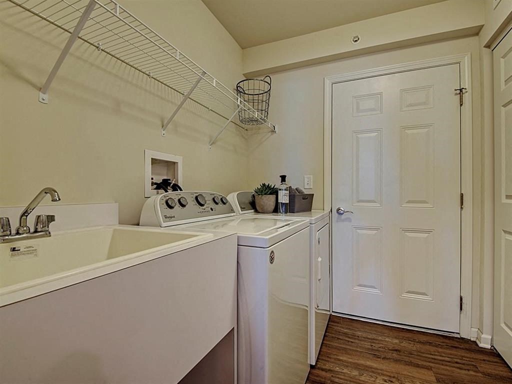 a kitchen with a stove and a sink and a door