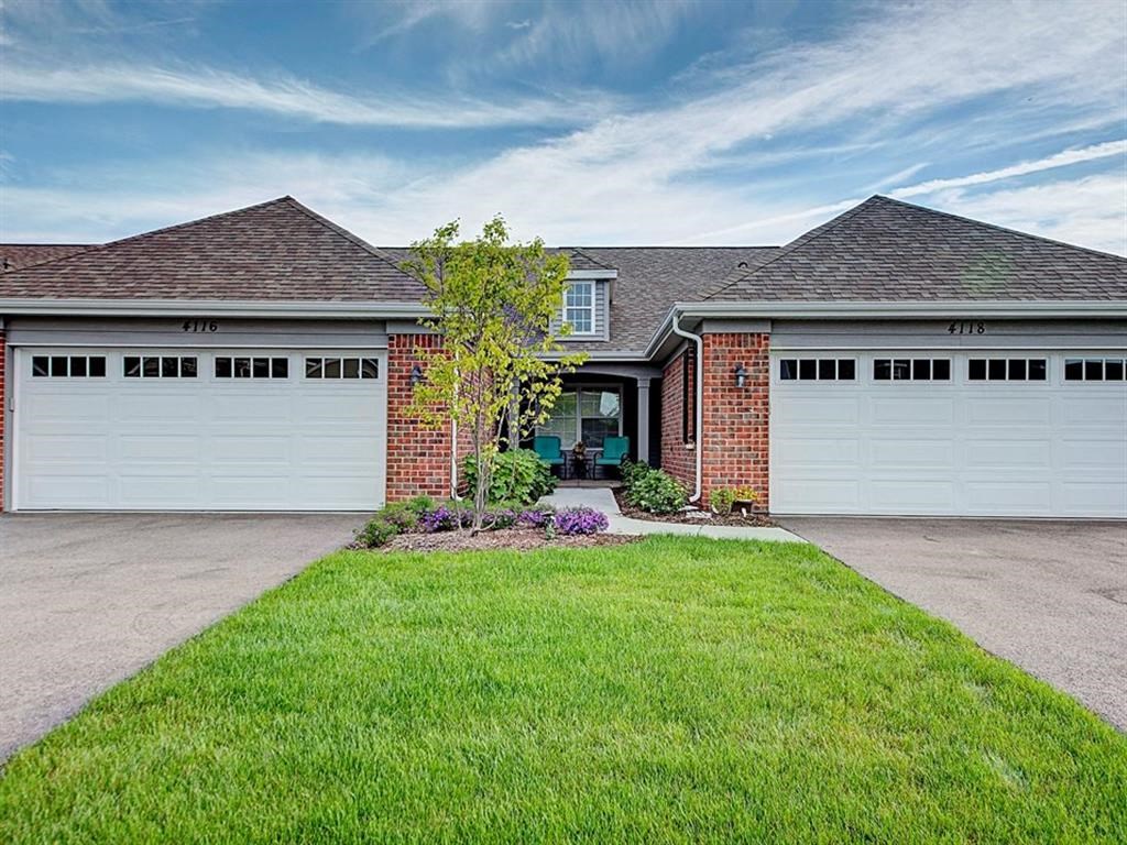 a house with two garage doors and a lawn