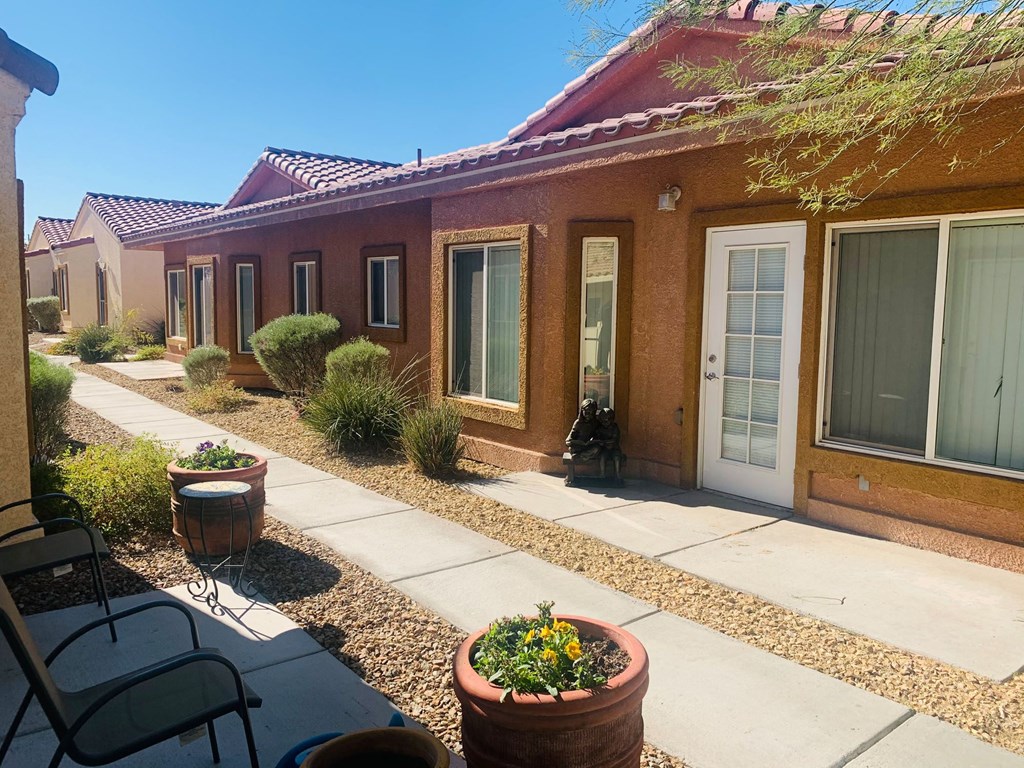 a building with a patio and chairs in front of it