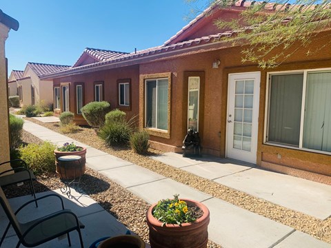 a building with a patio and chairs in front of it