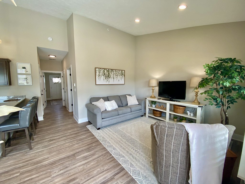 a living room with a couch and a chair in front of a tv