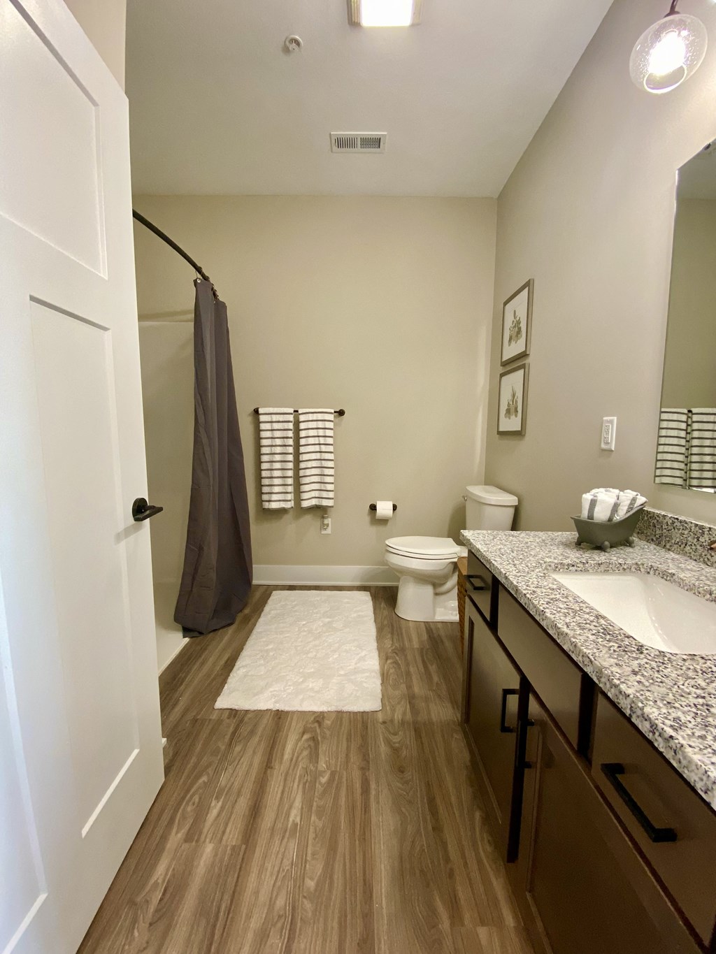 a bathroom with a shower toilet and sink