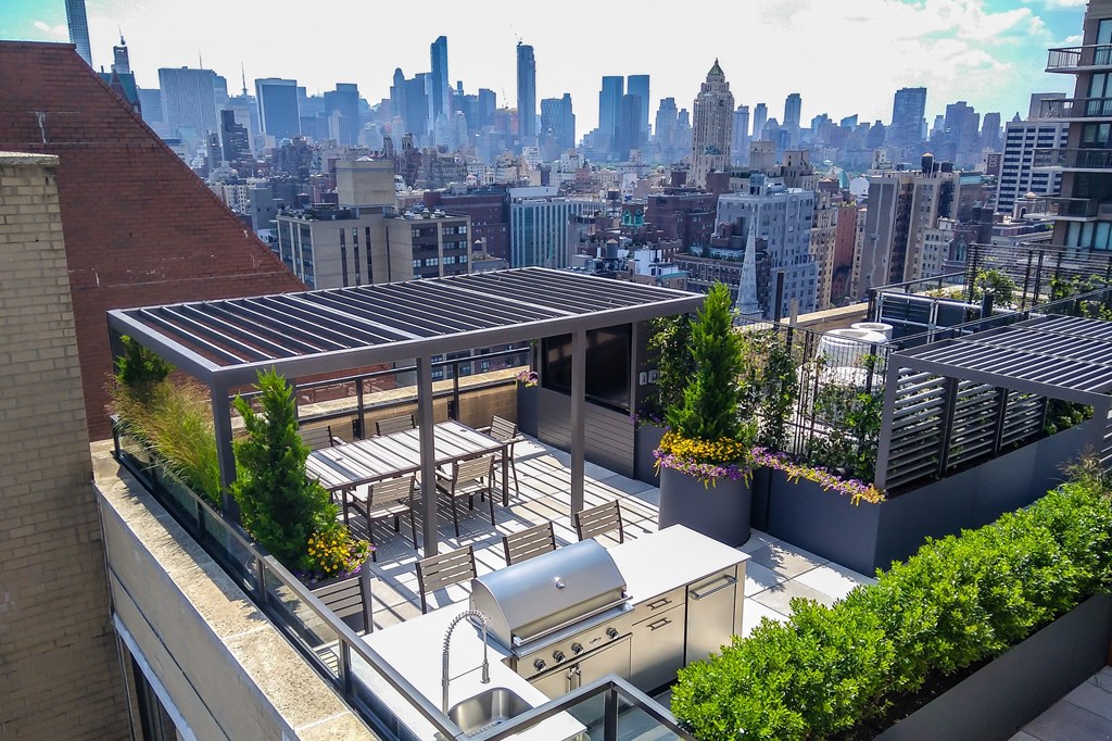 a rooftop patio with a city skyline in the background