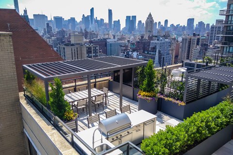 a rooftop patio with a city skyline in the background