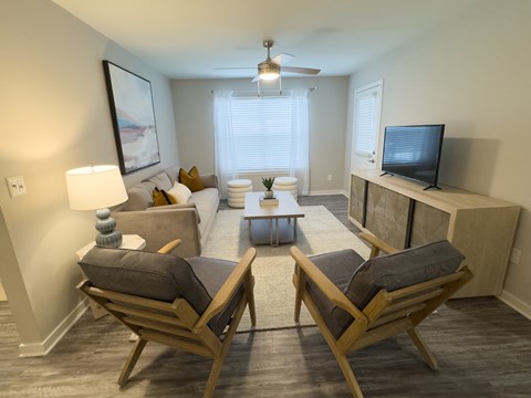 A living room with two chairs and a couch.