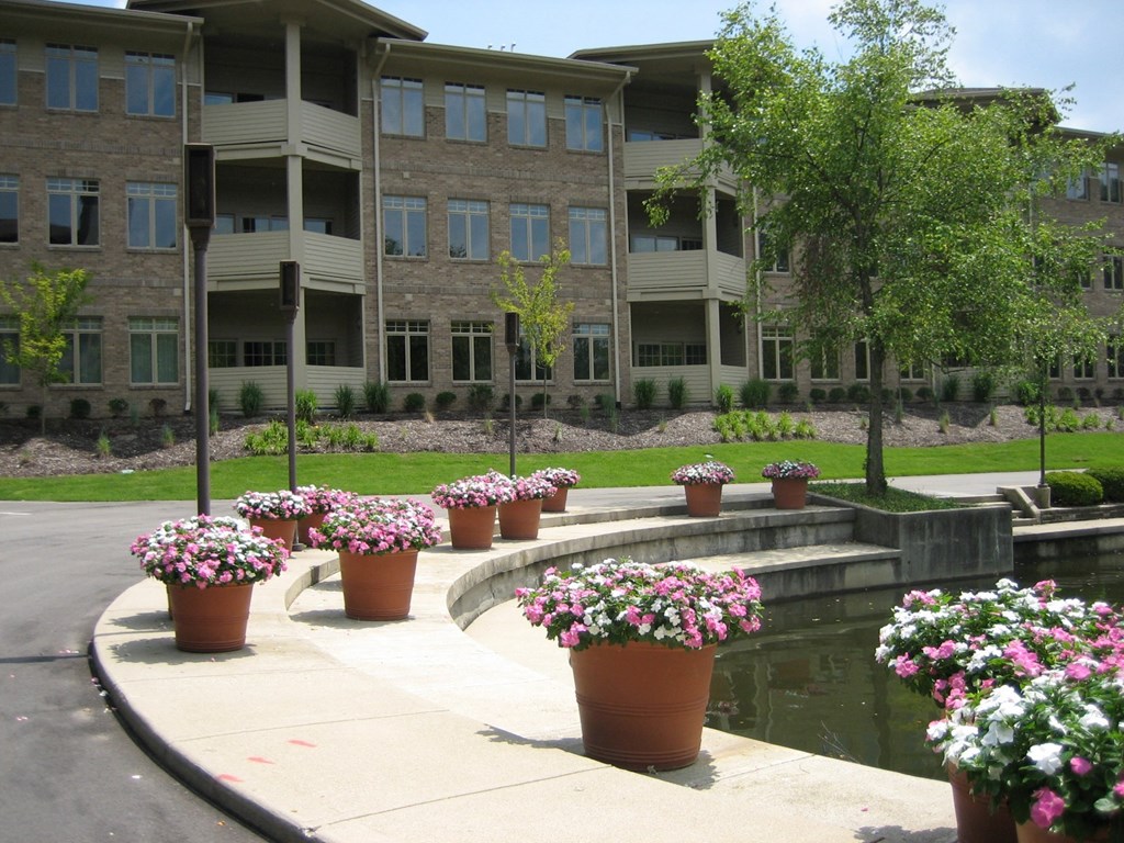 an apartment complex with potted flowers in front of it