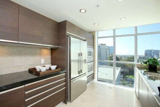 A modern kitchen with a view of the city.