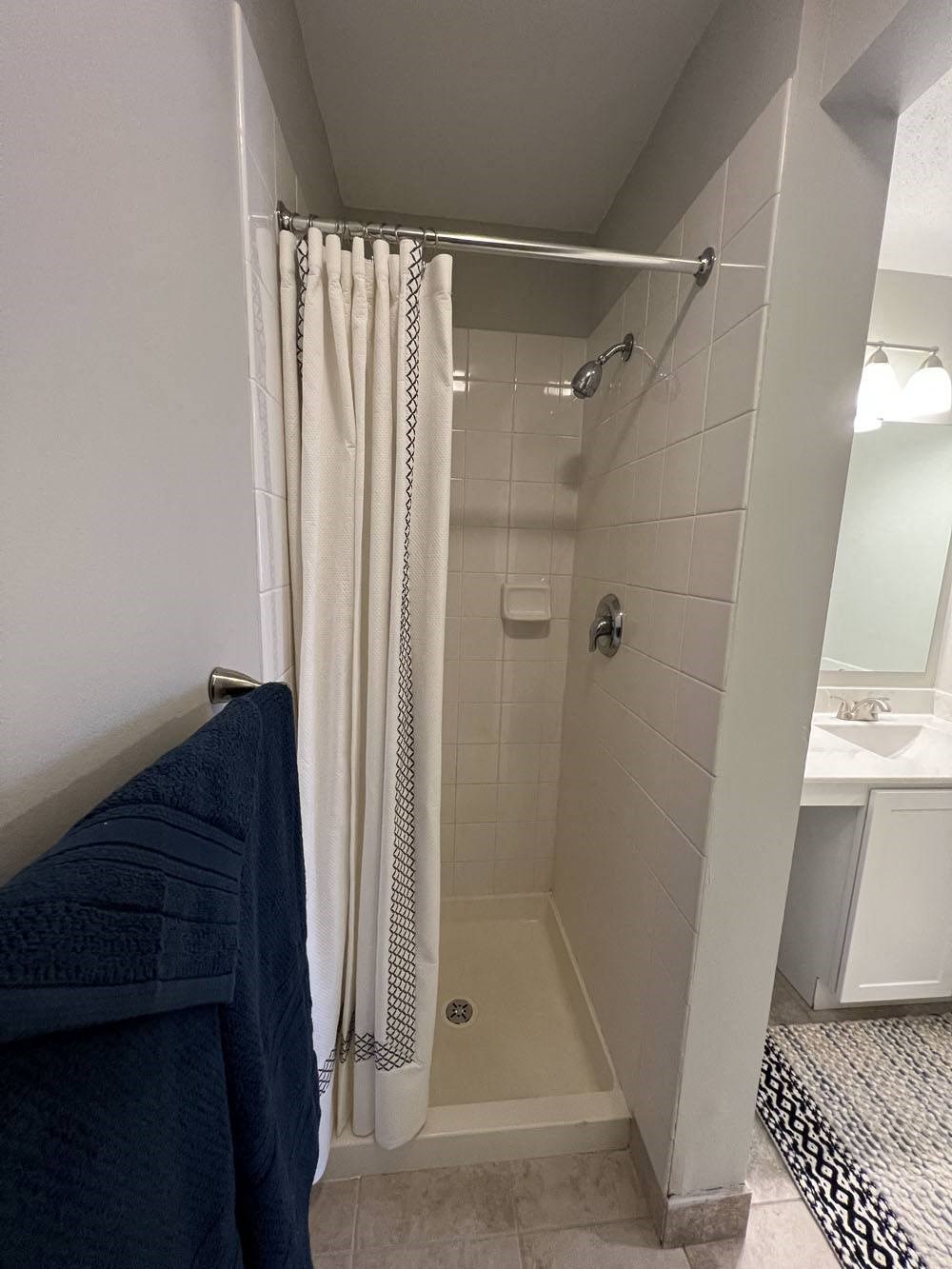 a small bathroom with a shower and a curtain