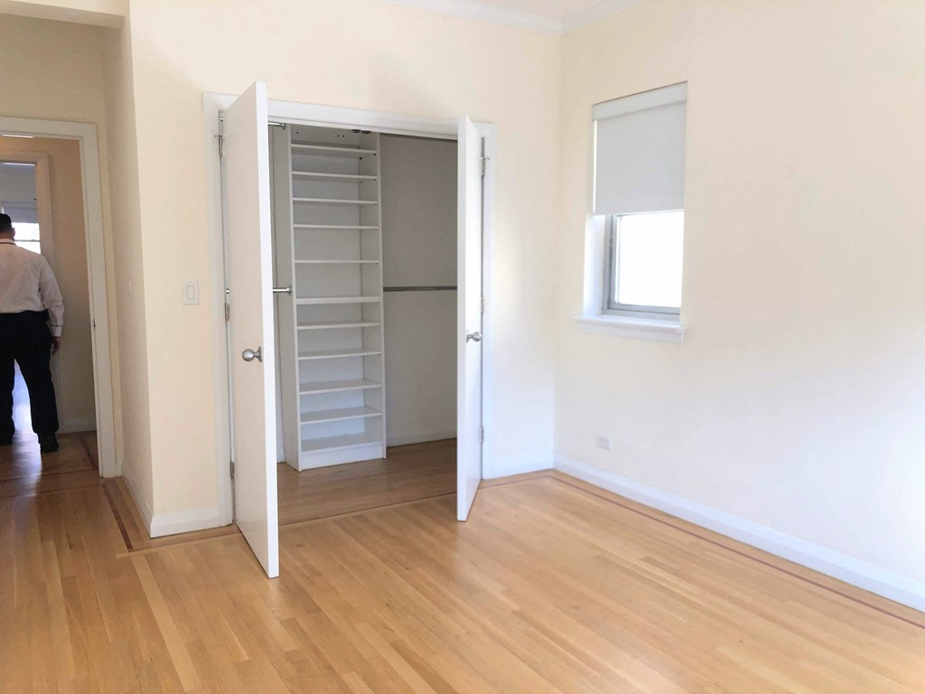 a bedroom with a closet and a window