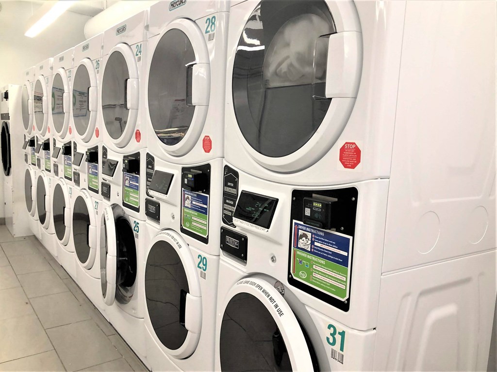 a row of washing machines in a laundromat