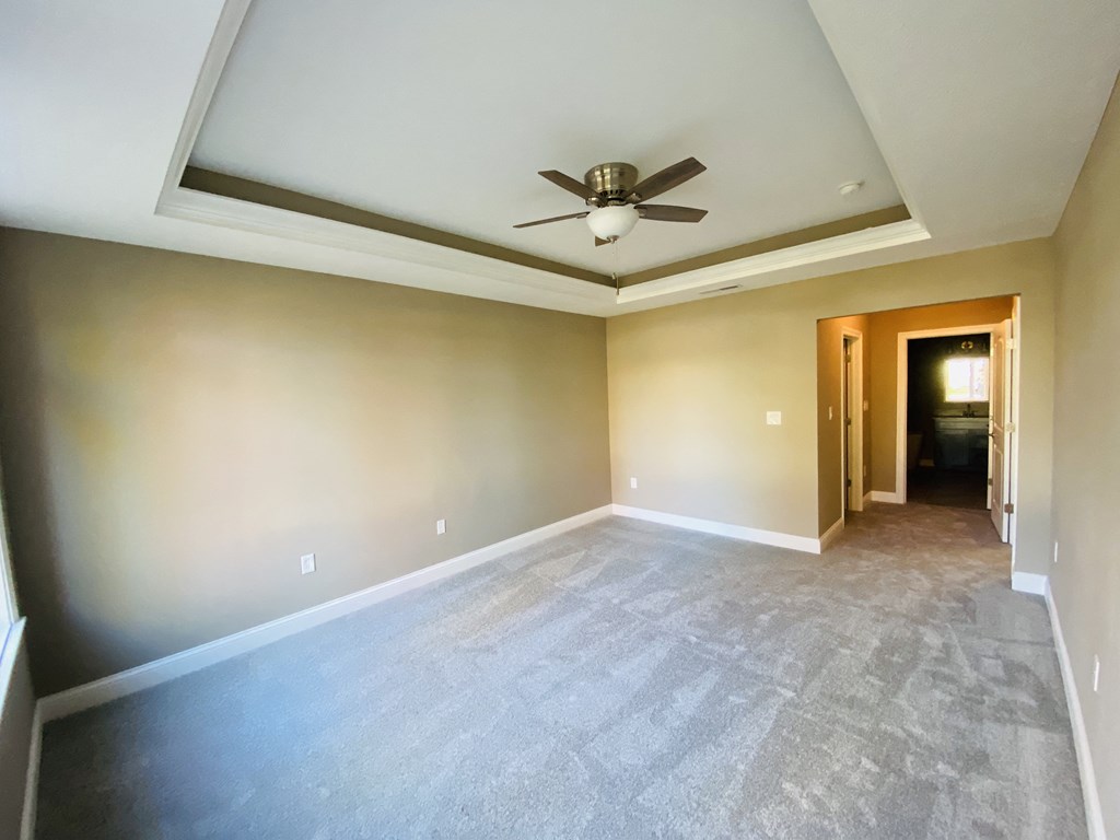 an empty room with a ceiling fan