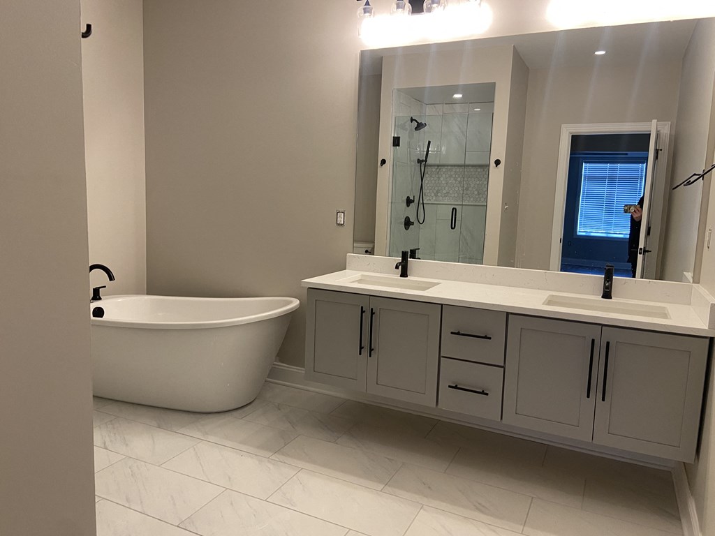 a bathroom with a bathtub and two sinks