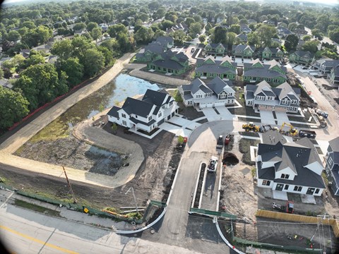 A construction site with a large building in the background.