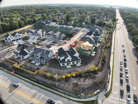 A bird's eye view of a construction site with multiple houses under construction.
