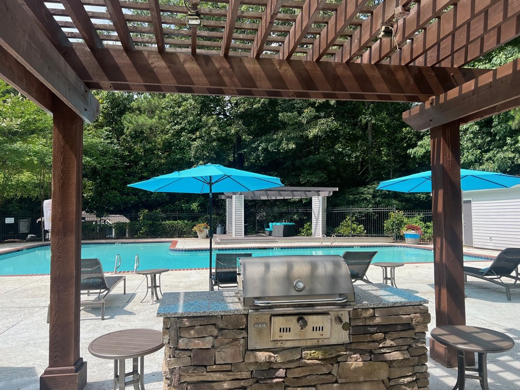 Place at Midway Douglasville GA a pergola with a grill and umbrellas overlooking a swimming pool