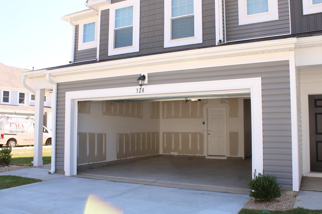 a garage door is open in front of a house
