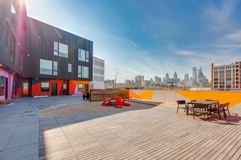 A modern building with a wooden deck and orange accents.
