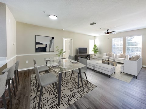 A modern dining room with a glass table and chairs.