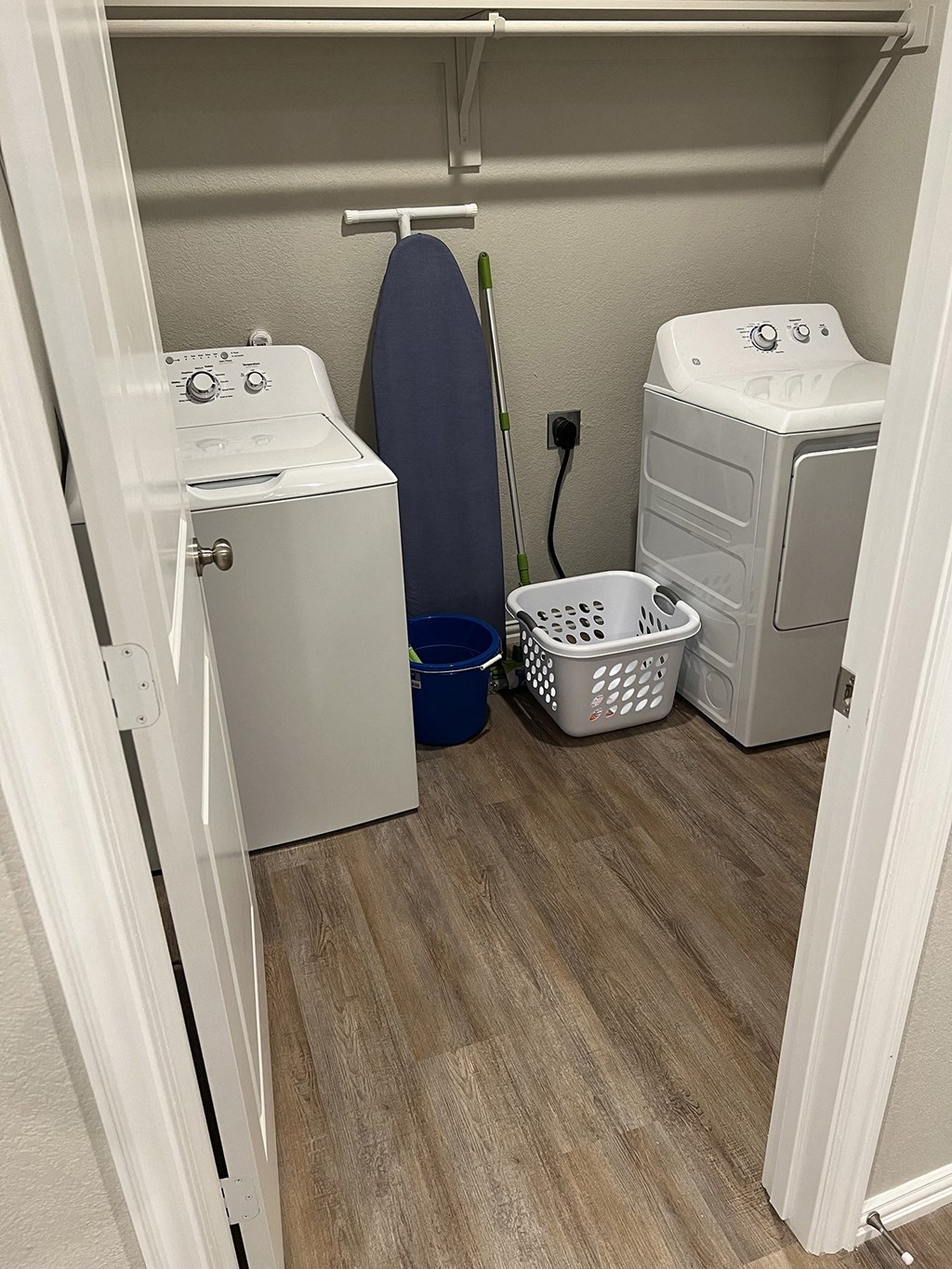 a laundry room with two washers and a dryer