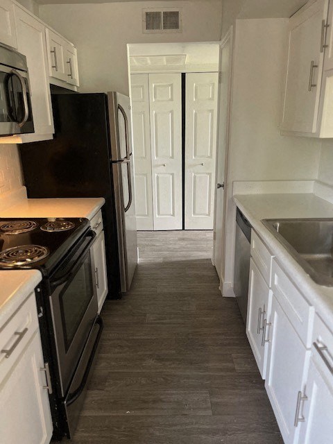 a kitchen with a stove a sink and a refrigerator