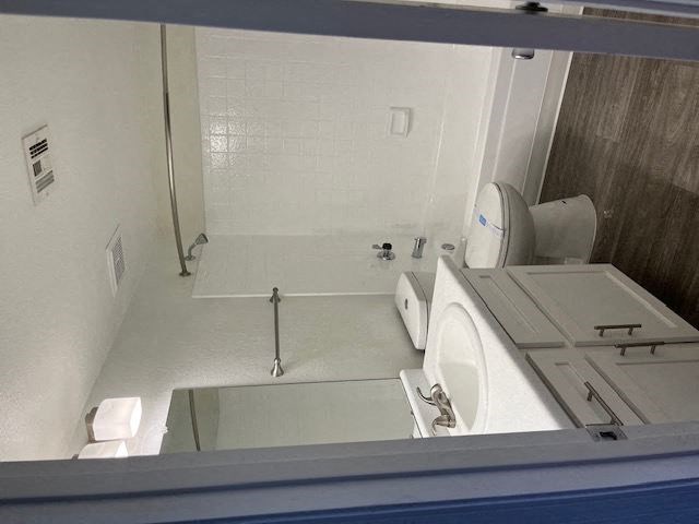 a bathroom with a toilet a sink and a tub