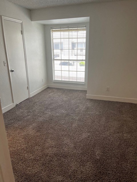 an empty room with a window and a door