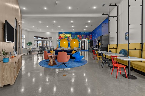 A colorful mural in a modern dining room with tables and chairs.