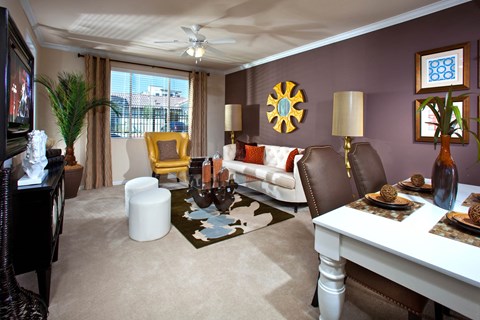 a living room with purple walls and white furniture